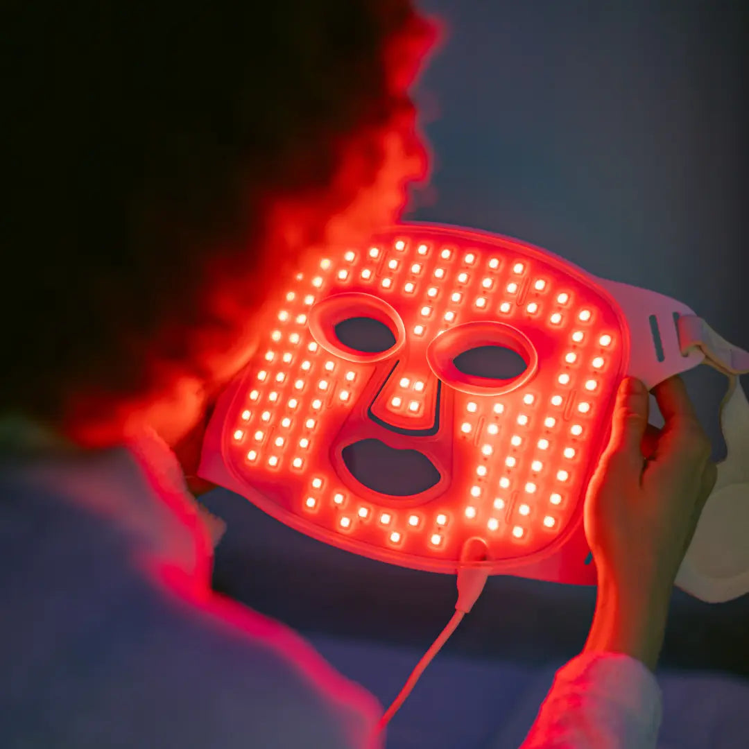 Woman wearing Skintekie LED face mask during 10-minute at-home skincare routine