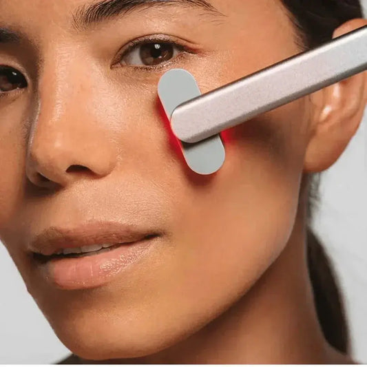 A picture of a lady using the 4-in-1-wand-red-light-therapy on her face
