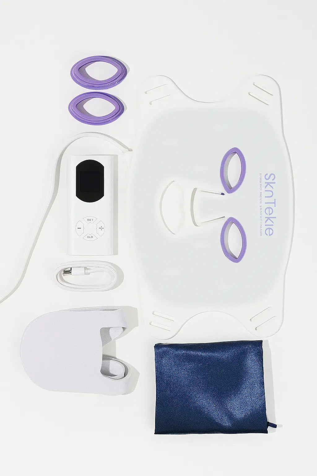 Skintekie LED face mask and rechargeable controller laid out together with connecting USB cable