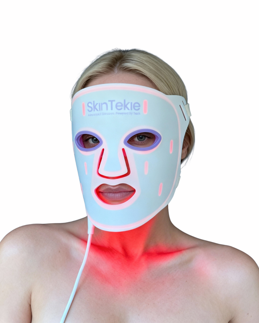 Person wearing a SkinTekie LED face and neck mask on a white background